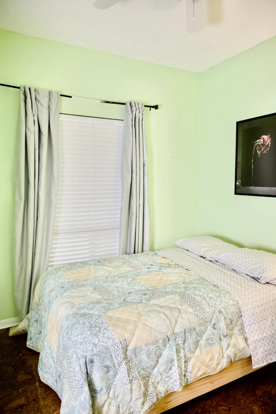Second bedroom with queen bed and soft green walls