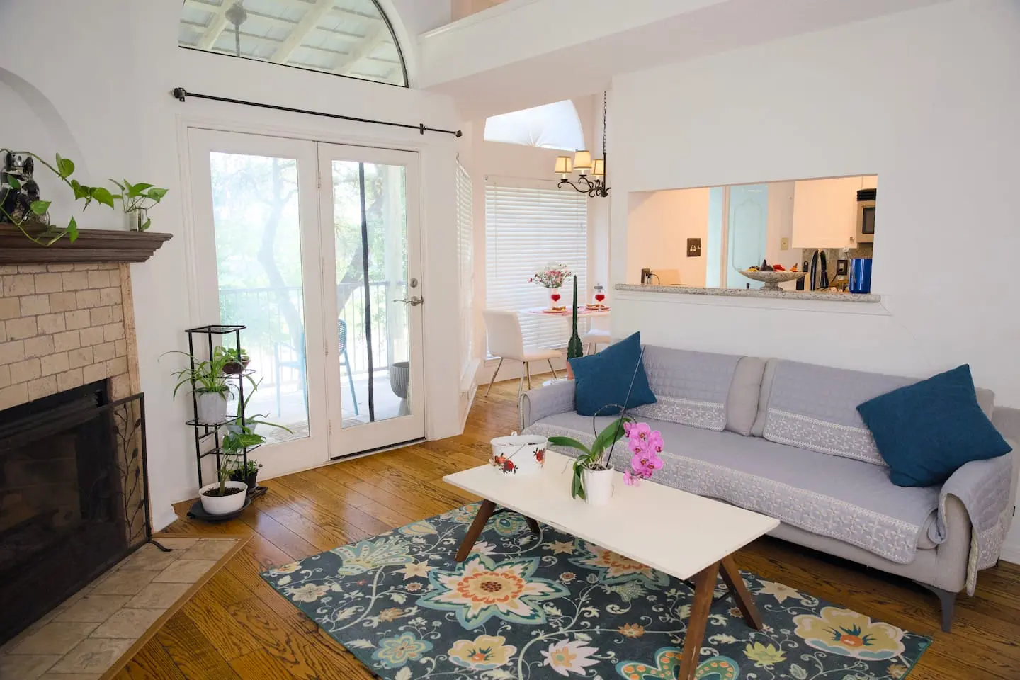 Living room with sofa, fireplace, and French doors