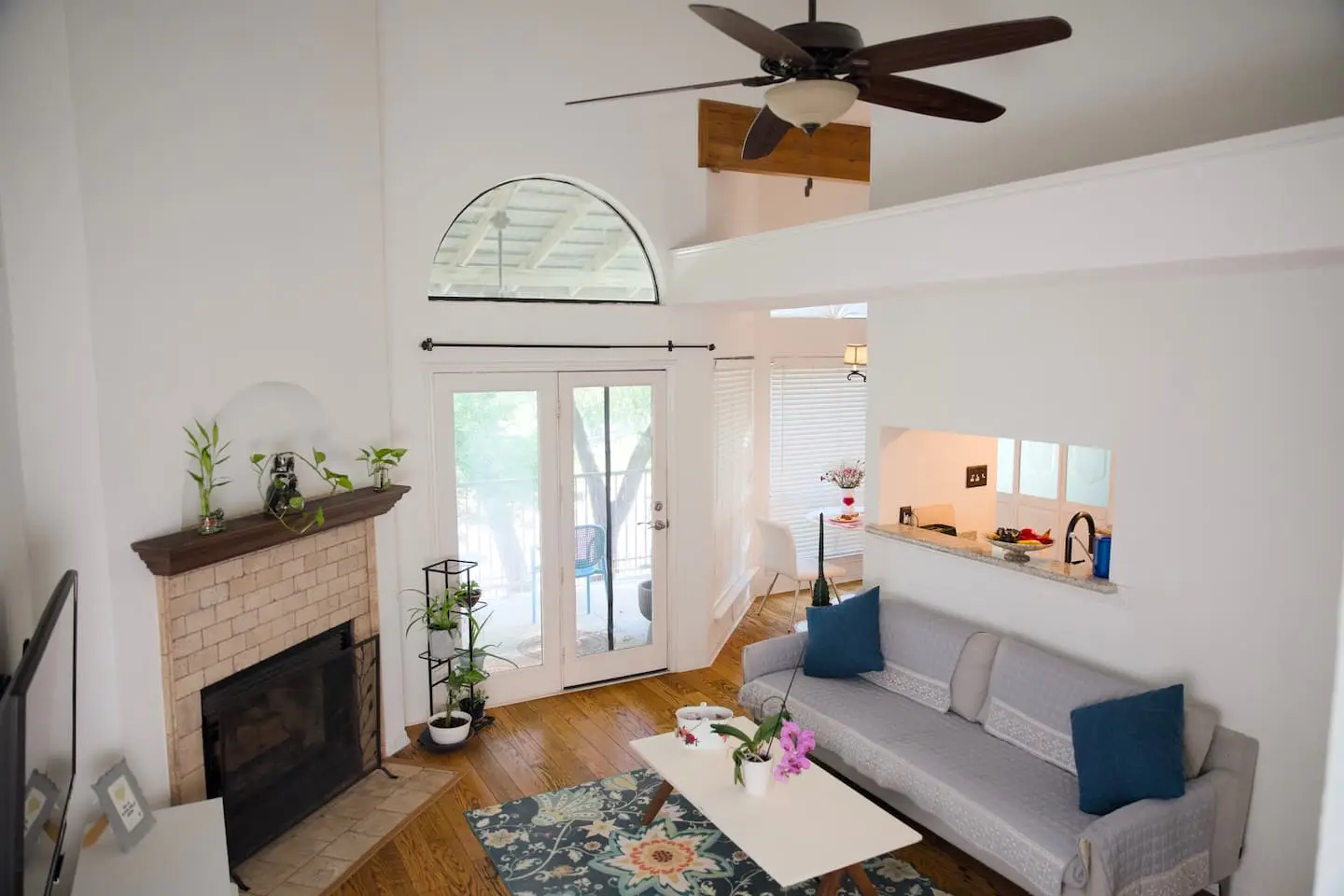 Living room from the dining area, with high ceilings