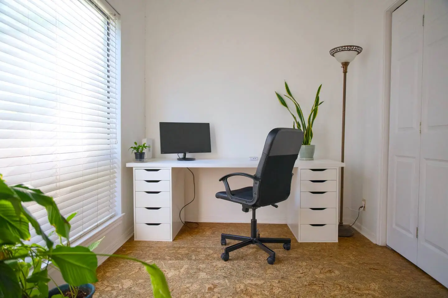 Workspace with desk, monitor, and office chair
